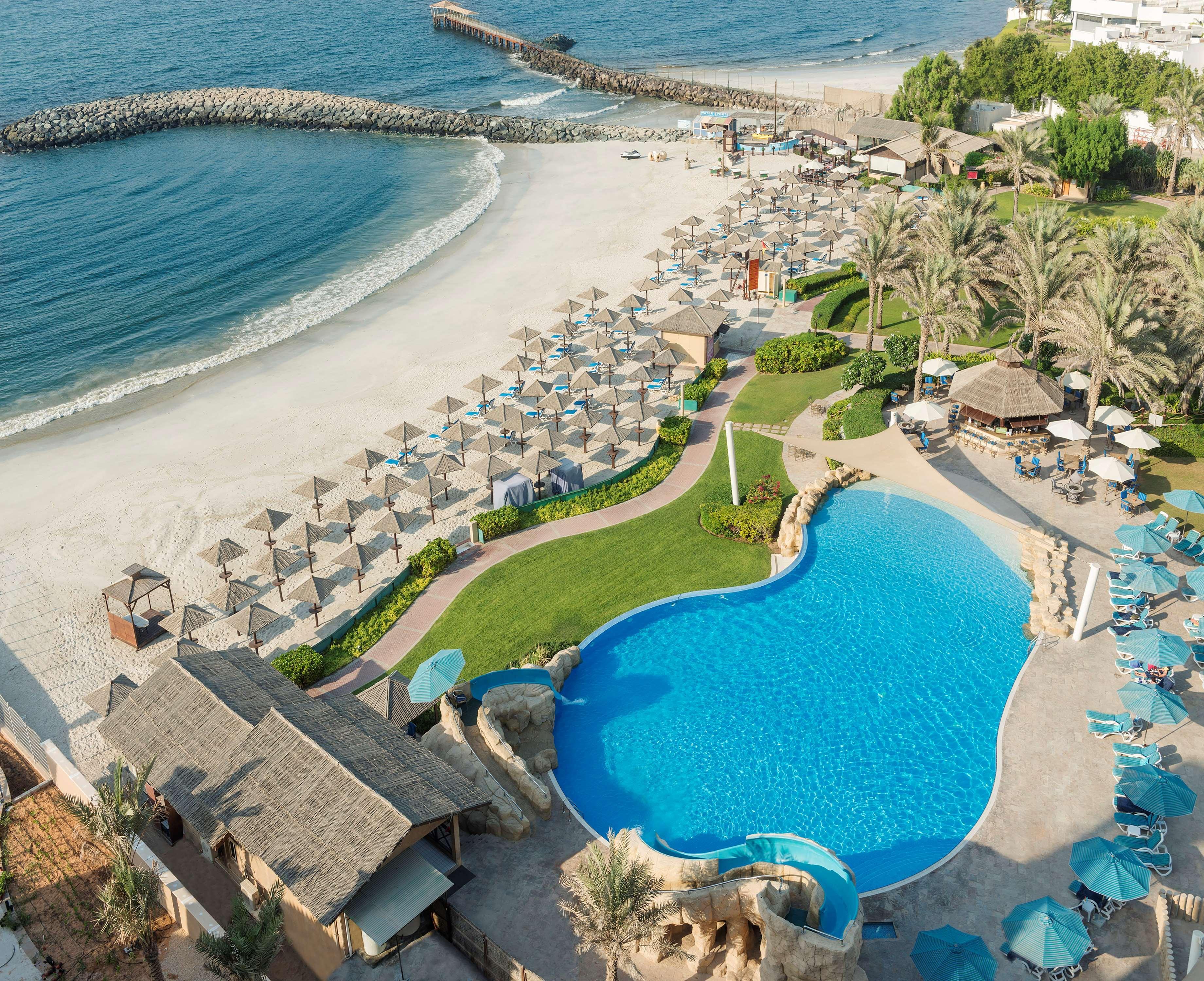 Radisson Blu Hotel, Ajman Exterior photo Aerial view of the beach and pool at the resort